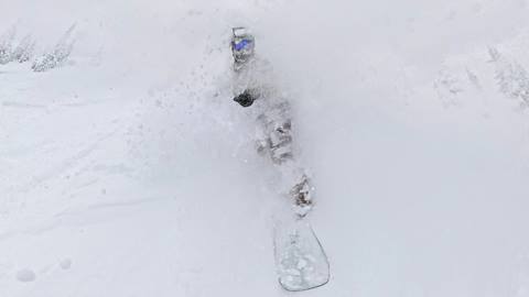 snowboarder going through powder