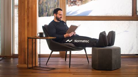 man sitting in leg compression nortec