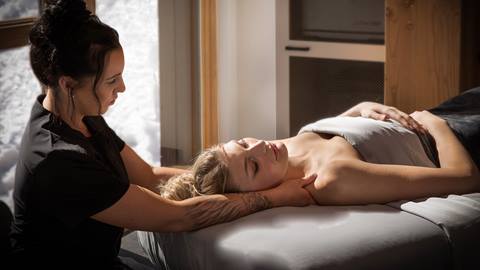 Massage therapist delivering a signature spa service at Cambium Spa at Schweitzer