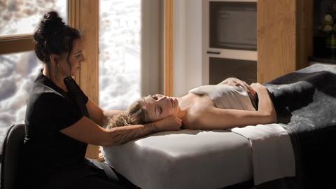 a woman receives a professional therapeutic massage treatment at the cambium mountain spa facility