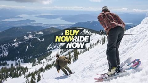 Skiers on a slushy spring day at Schweitzer with a view of Sandpoint. 