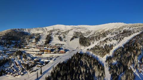 drone image of schweitzer mountain with blue skies