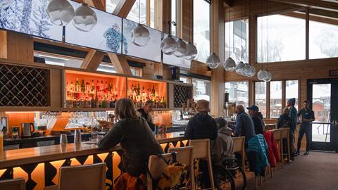 interior crows bench with people sitting at the bar