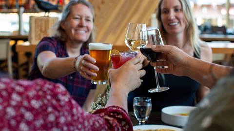 group of people clinking their glasses at Crows Bench restaurant at Schweitzer