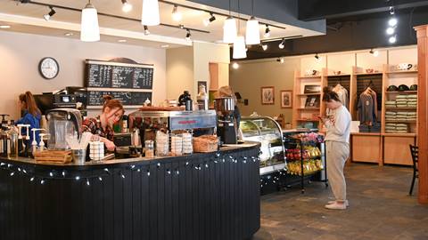 Interior of Mojo Coyote Cafe with baristas making espresso drinks