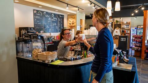 image of barista handing drink to customer at Mojo