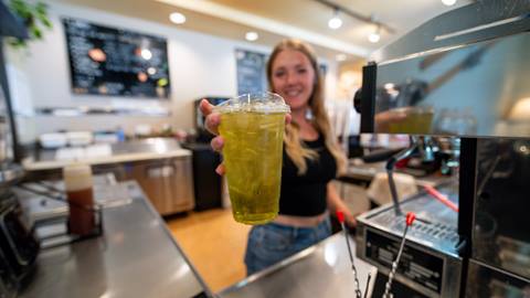 image of barista holding out flavored red bull from Mojo