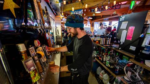 image of bartender pouring beer at Taps at Schweitzer