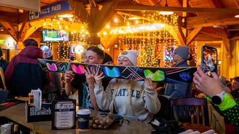 image of two people taking shot with shot ski at Taps at Schweitzer