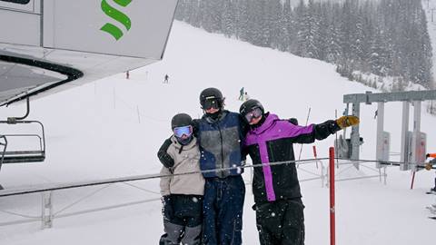 three young people in line at the Basin Express chairlift at Schweitzer