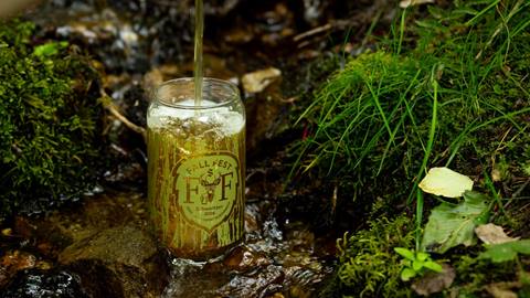 image of fall fest beer glass with beer being poured into it 