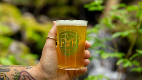 image of hand holding tasting glass of beer