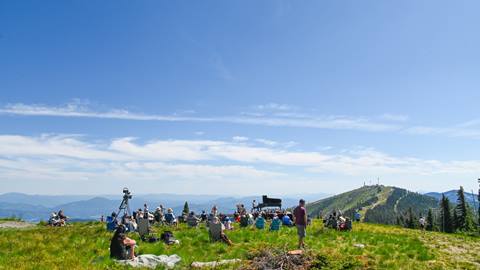 Image of large group of people enjoying a live classical piano performance at the summit of Schweitzer