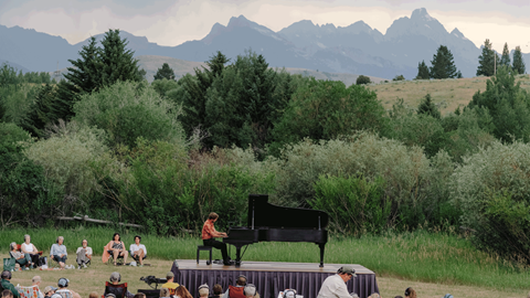 piano performance with mountains in the background