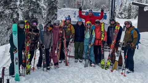 group photo of cat skiers with guide