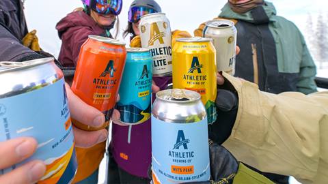 group of people holding athletic beer cans