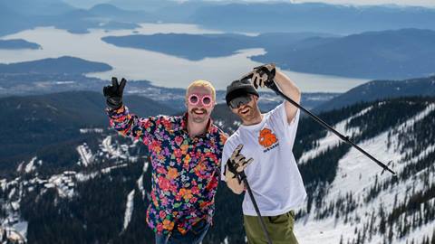two people smiling and enjoying spring skiing at Schweitzer
