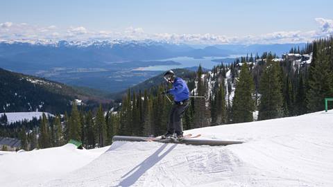 skier doing park trick on rail at Schweitzer