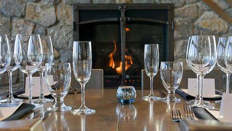 image of empty glasses on table in front of fire place