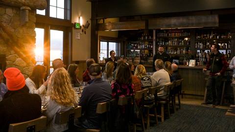 group of people enjoying wine and dinner at Sky House at Schweitzer