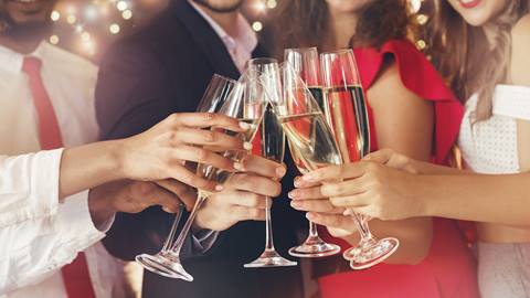 A group of guests raises their glasses for a celebratory toast during a formal event at Schweitzer.
