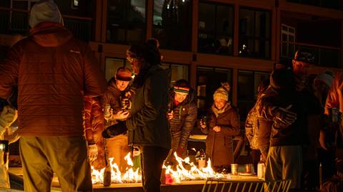 group of people enjoying firepits outside of Crow's Bench at Schweitzer