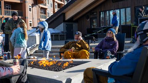 people sitting and enjoying fire pit on Crow's Bench patio
