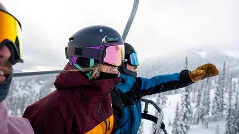 people sitting on chairlift during snowy winter months at Schweitzer