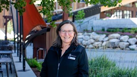 picture of woman in front of trees and walkway at schweitzer