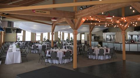 North Room set up for a wedding reception with large round tables and dancefloor. 