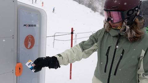 A skier scans an Ikon Pass at an Axess gate to access the mountain at Schweitzer.