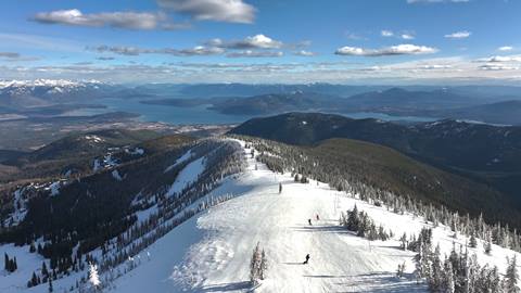 drone spring skiing lake view snowboard mountains
