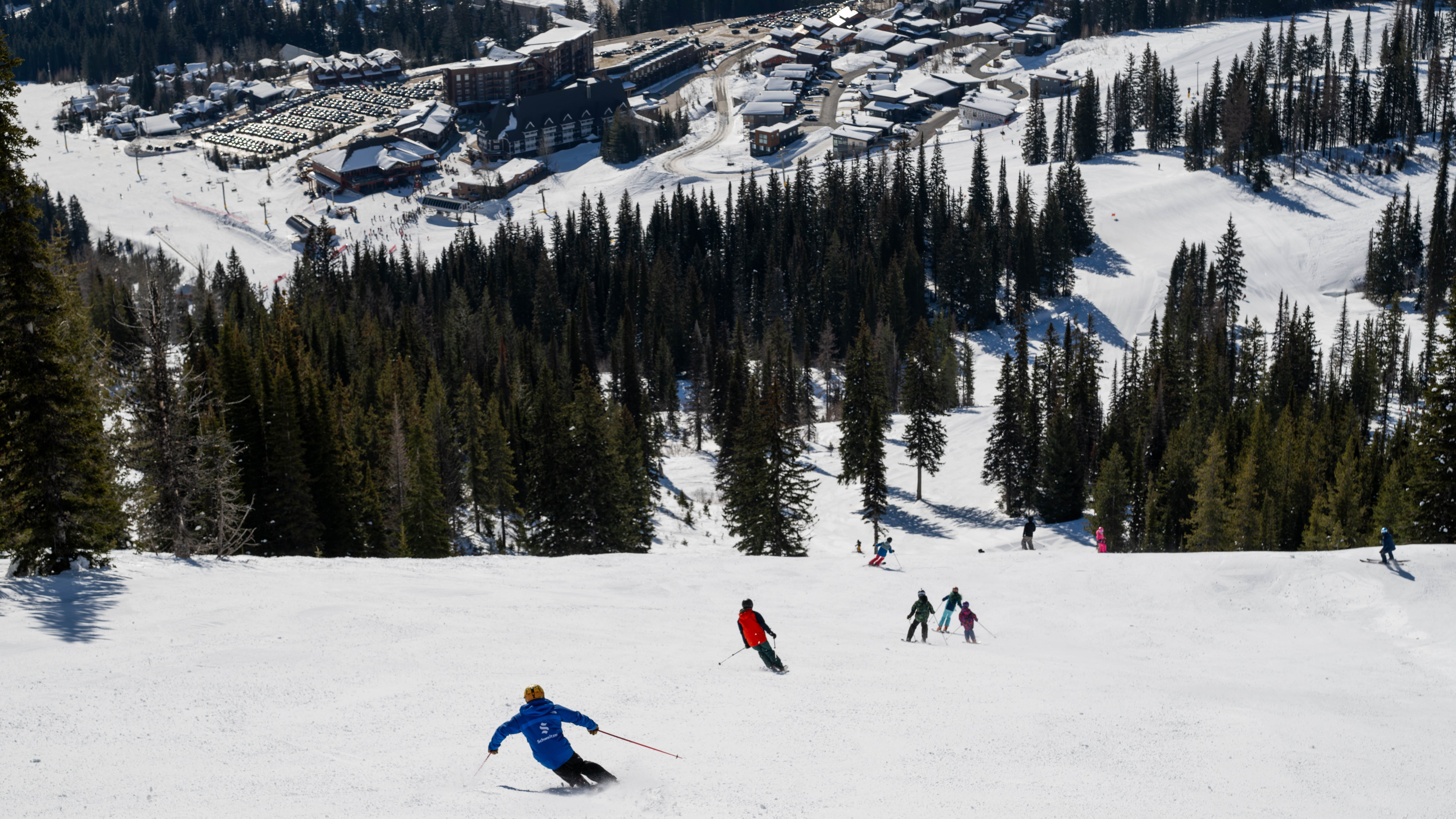 skier going down  slopes with Village background