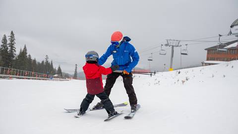 schweitzer ski instructor teaching little skier