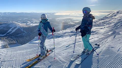 two people in ski gear on a groomed slope at schweitzer in one of the funatics multi-week ski lesson programs