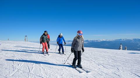 guests at schweitzer learning new techniques during ski lessons on wide open snow covered slopes