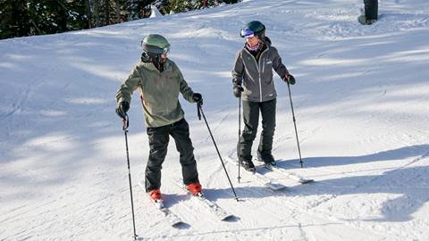 ski instructor with learning skier