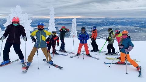 a group of children and instructors during a kids group ski lessons session at schweitzer mountain resort