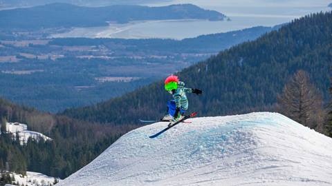 kid skier jumping in terrain park