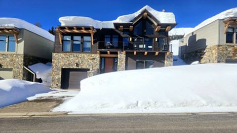 scotchman view vacation rental at schweitzer on a winter day with deep snowbanks and a modern mountain lodge design