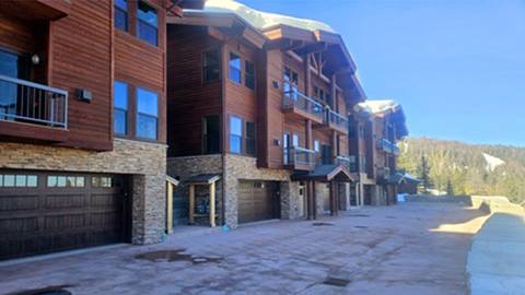 Condo vacation rentals at Schweitzer Resort with private garages and balconies overlooking the surrounding forested slopes