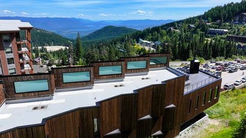 drone view of the humbird hotel and background of lake pend oreille and the cabinet moutains