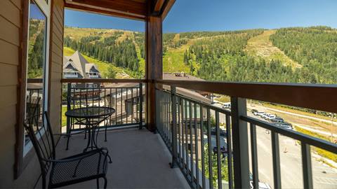 Patio view of a White Pine condo looking out onto the slopes of Schweitzer in summer