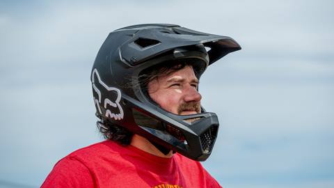 side view of full face mountain bike helmet worn by rider, available through Schweitzer's mountain bike gear rental shop