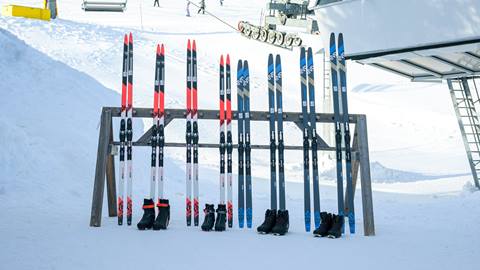 multiple cross country ski rentals leaning on rack at schweitzer