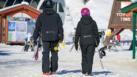 two people walking through Schweitzer village wearing goretex snow gear