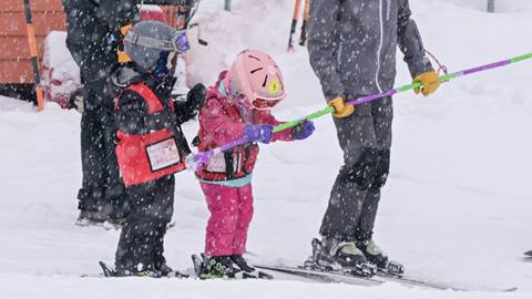two young children in their 6-and-under ski rental packages at schweitzer mountain