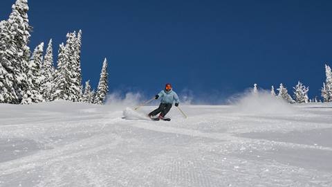 skier using performance ski rentals at schweitzer carving on fresh groomed terrain