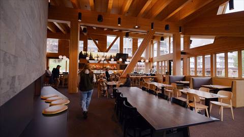 interior photo of crows bench restaurant at Schweitzer with guests walking through and guests dining