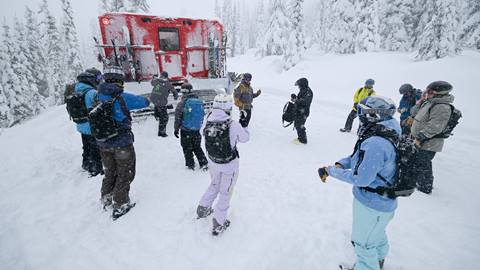 group of guests getting ready to go cat skiing